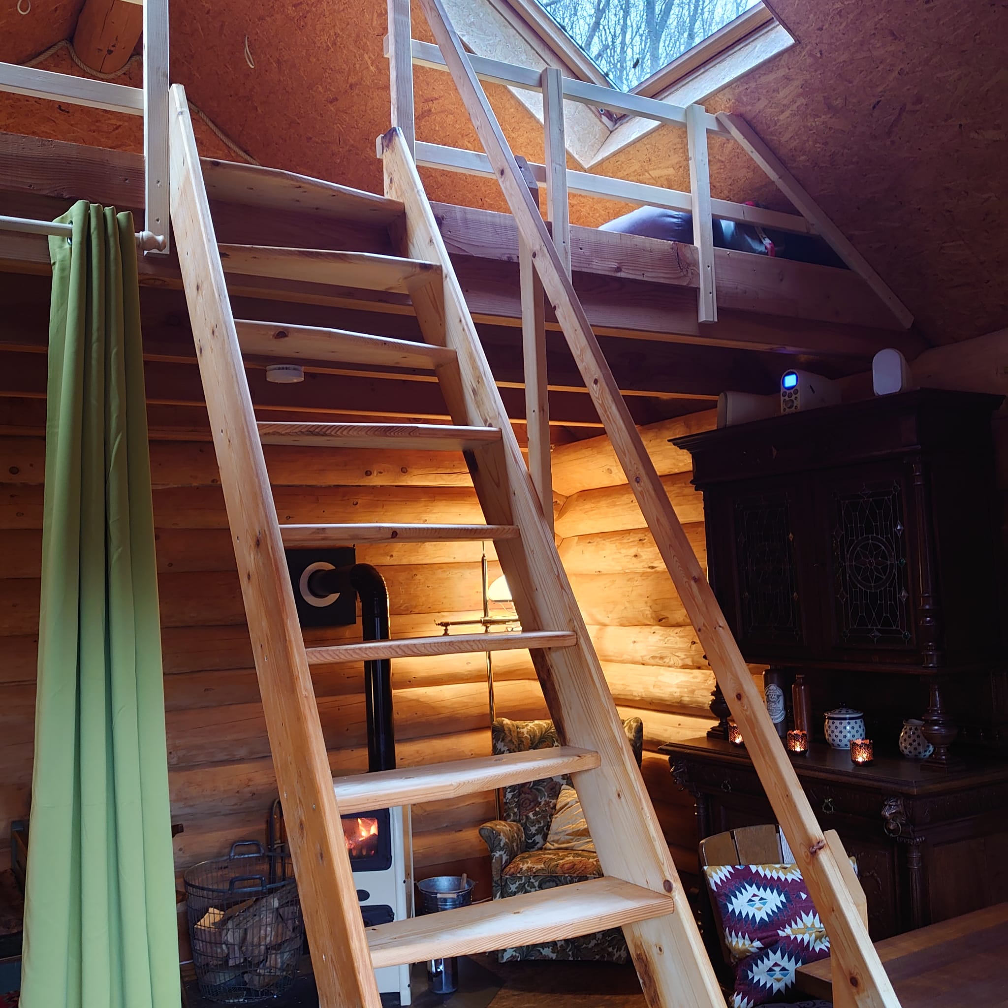 Treppe zur Empore mit Schlafplätzen, mit Blick in den Sternehimmel.